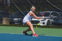 An IU Southeast women's tennis player returns a ball.